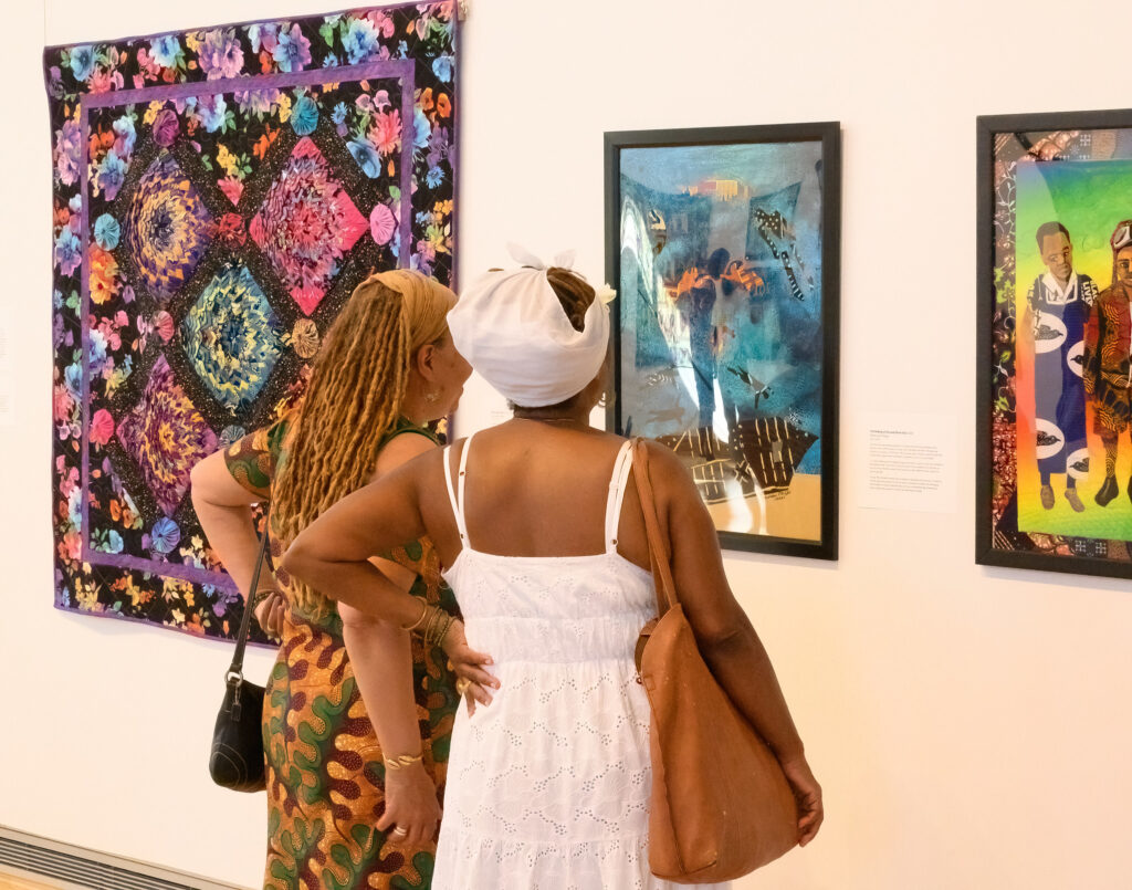 Visitors viewing artwork in local gallery