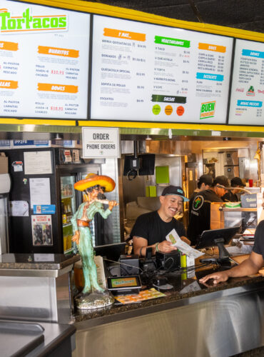 Restaurant staff helping customers at ordering counter