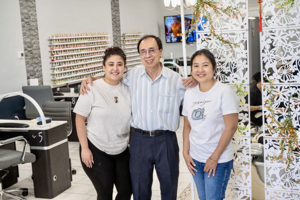 Small business owners smiling inside their shop