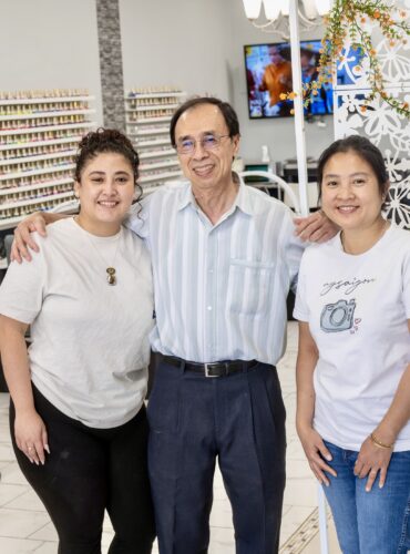 Small business owners smiling inside their shop